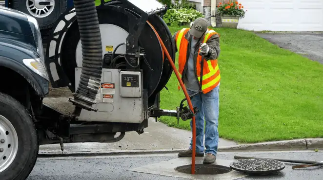 Technician using specialized drainage equipment for sewer line cleaning and foundation protection in Baltimore, MD