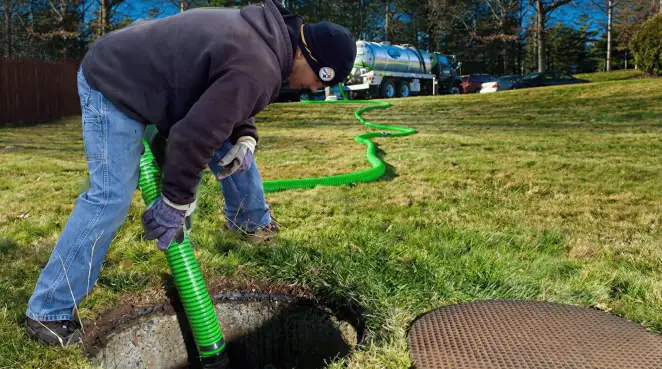 Service technician performing residential septic pumping and drainage maintenance in Baltimore, MD